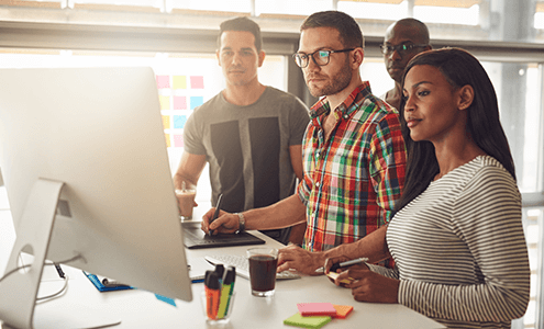 https://canadianvisa.org/blog/jobs/work-in-canada-top-7-seven-jobs-in-2018 Group of workers looking at work sheets on a computer
