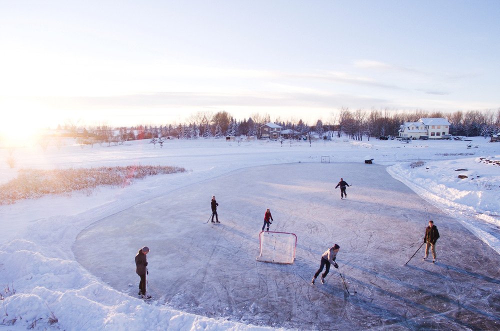 Game of ice hockey on frozen pond Canada