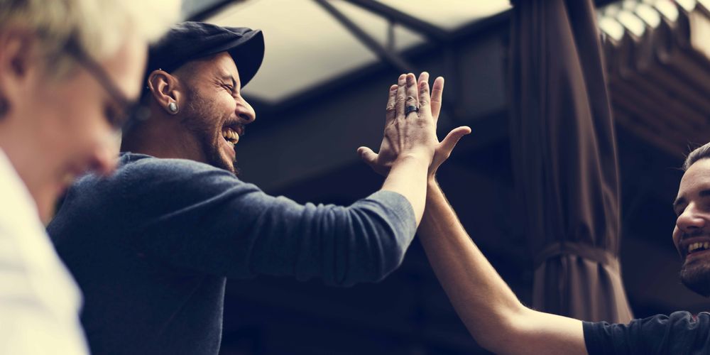 10 Fun Facts about Hamilton two men high-five each other