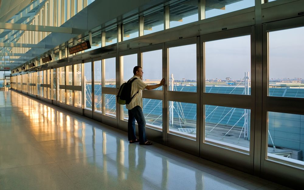 10 Fun Facts about Mississauga Man watching a plane take off at Toronto Pearson International airport.
