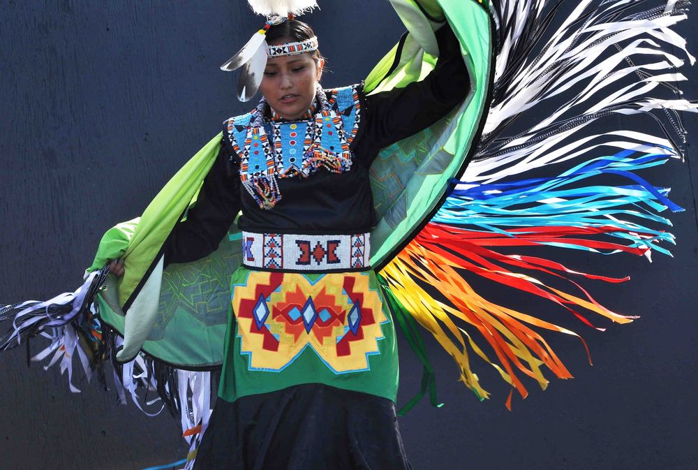 Top 10 Reason to Visit Saskatoon A young native american women perform a traditional dance for her audience