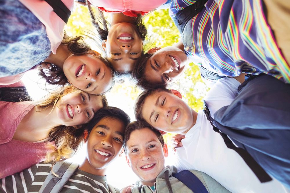 Cost of Living Charlottetown students standing in a circle looking in