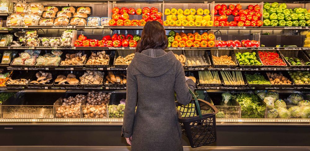 Cost of Living in Halifax woman browsing groccery shop for fresh vegetables