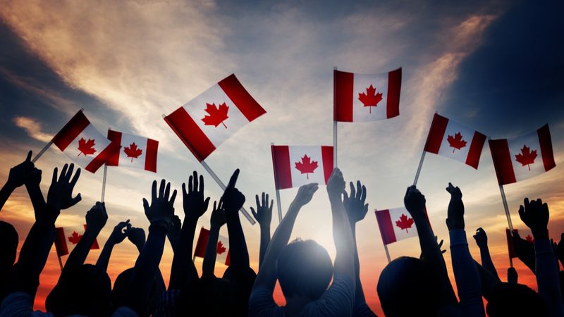 silhouettes-of-people-holding-canadian-flag-how-to-immigrate-to-canada-from-singapore-in-2021