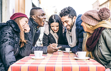Benefits to studying in Canada group of young people laughing over coffee