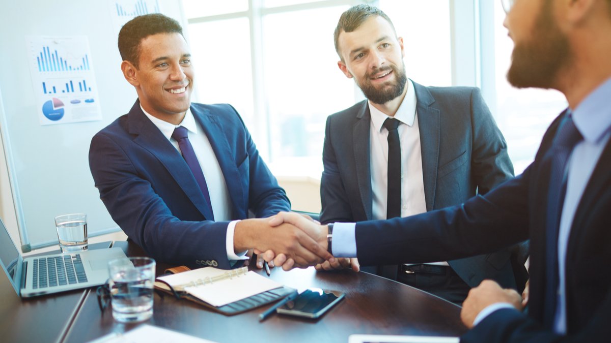 businessman shaking hands in meeting | How to Apply for the Canadian Experience Class (CEC