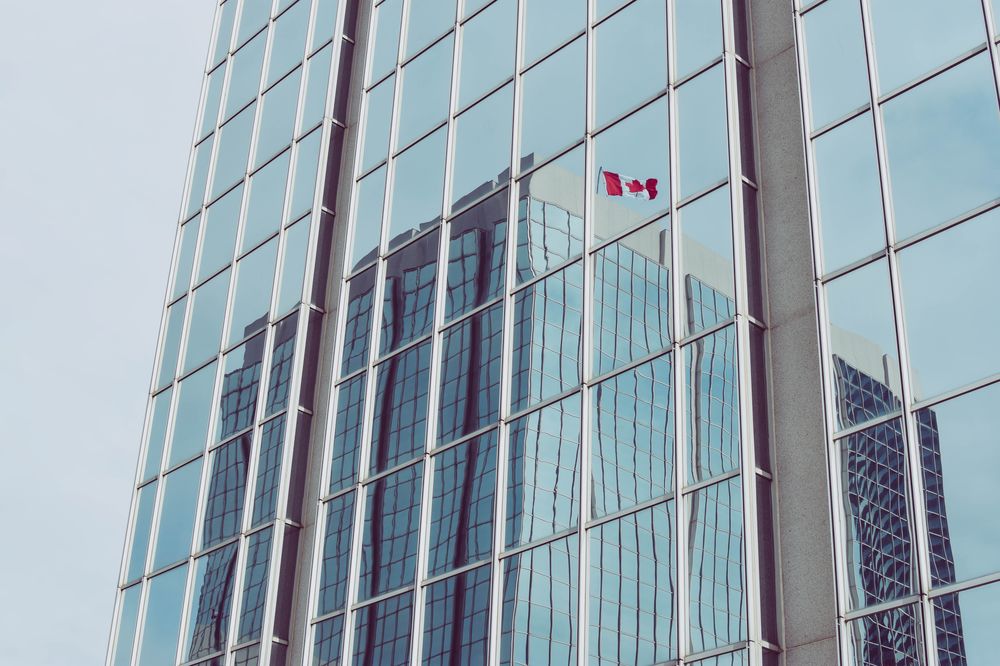 Canadian flag reflected in a high rise building