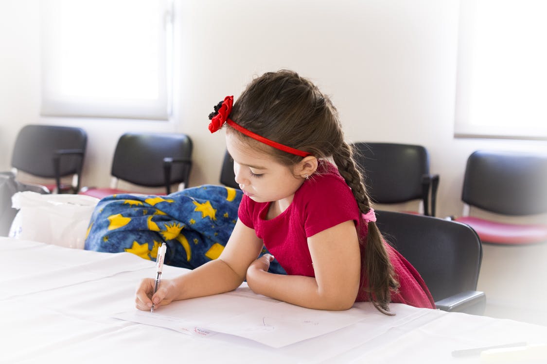 cute primary student working at desk