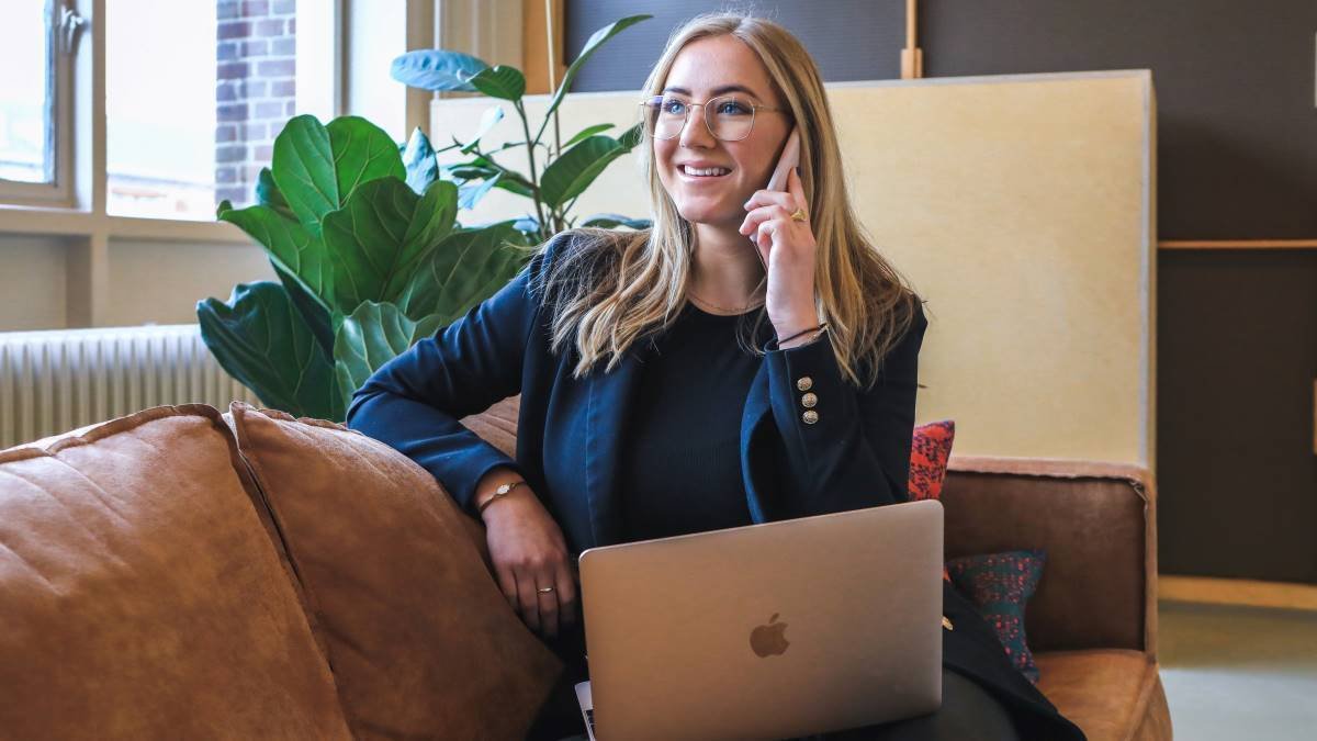 woman-using-laptop-and-phone-canadian-jobs-that-pay-well-without-a-degree