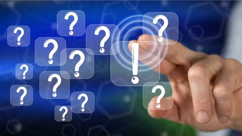 What's the Difference Between the FSWP & the FSTP? hand selecting virtual question mark | FAQs: The Process of Canadian Immigration