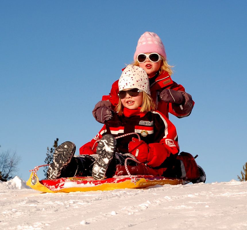 Living the dream in Canada’s winter sibling sledding down snowy slope