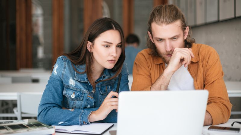 man-and-woman-looking-at-laptop