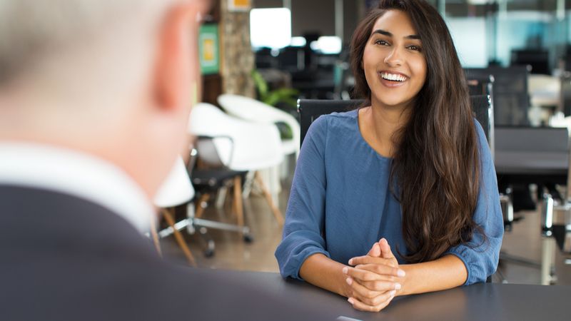 Young female candidate laughing at job interview