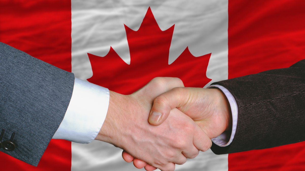 to-men-shaking-hands-in-front-of-canadian-flag-faqs-everything-you-need-to-know-about-business-immigration-to-canada