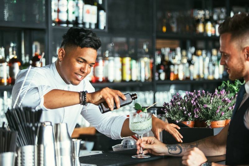 Top 10 Highest Paying In Demand Unskilled Jobs in Canada in 2020 waiter and bartender pouring drink | jobs in Canada
