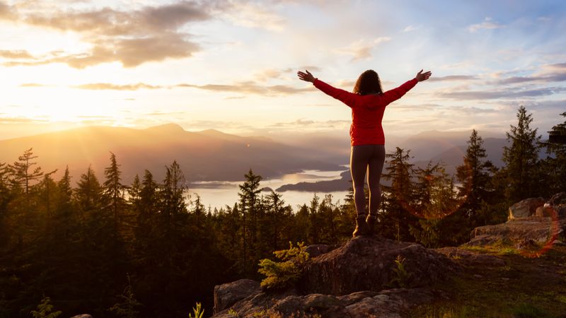 Get a Fast-Tracked Canadian Work Permit From the U.K. woman-on-top-of-mountain-get-a-fast-tracked-canadian-work-permit-from-the-uk