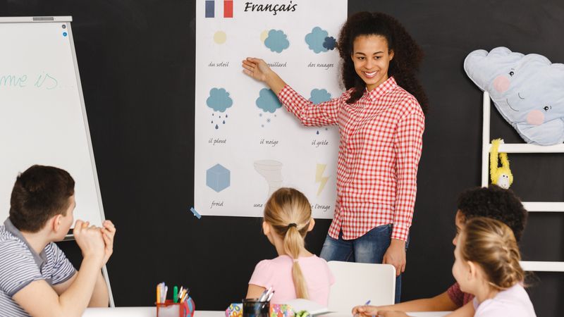 6 New Canadian Immigration Programs to be Launched! Young woman teaching kids french words during classes | Canadian Immigration Programs